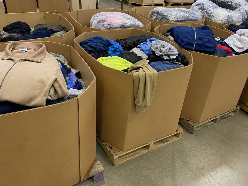 Gaylord boxes filled with premium credential clothing ready for thrift store overflow pickup
